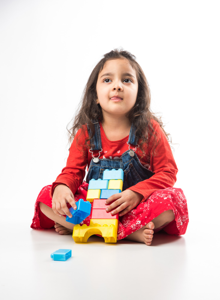 cute-little-indian-asian-girl-playing-with-colourful-block-toys-white-background